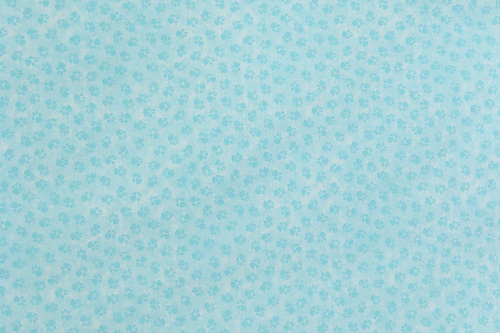 Paw print fabric in light teal from the "Dog On It" collection by Benartex